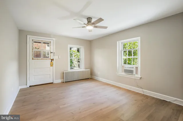 a kitchen with granite countertop a stove top oven and cabinets