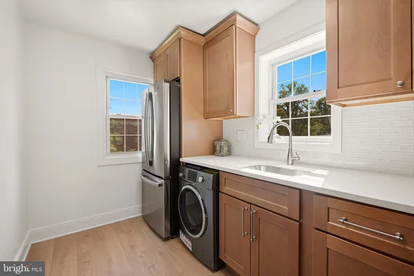 a utility room with sink dryer and washer