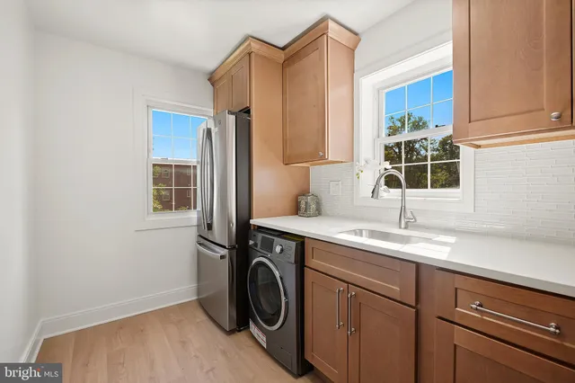 a utility room with sink dryer and washer
