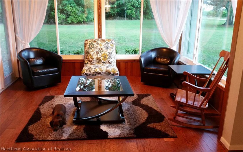 1397 Popash Road Wauchula, FL 33873 - Photo 3 of 5 a living room with furniture and a floor to ceiling window