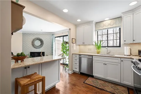 a kitchen with a sink appliances and cabinets