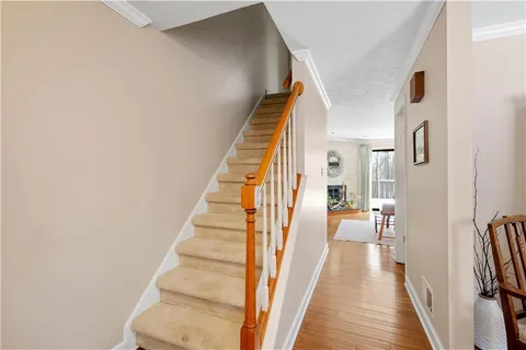 a view of a hallway with wooden floor and entryway