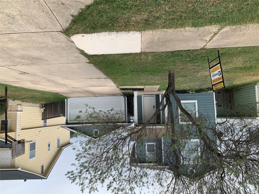 11904 Lima Drive Manor, TX 78653 - Photo 1 of 10 a front view of a house with a yard and garage