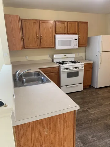 a kitchen with a stove a sink and a refrigerator