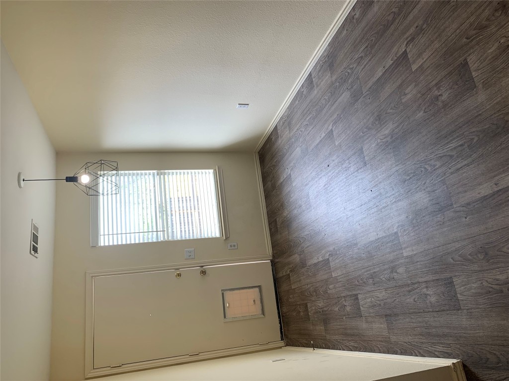 11904 Lima Drive Manor, TX 78653 - Photo 4 of 10 an empty room with wooden floor and windows