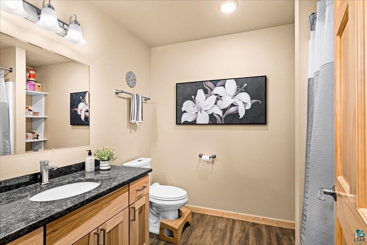 11411 South 3rd Street East Solon Springs, WI 54873 - Photo 15 of 40 features beautiful Hickory Cabinetry, Granite Counters, combo Tub/Shower, Wood-Look Vinyl Plank Flooring.