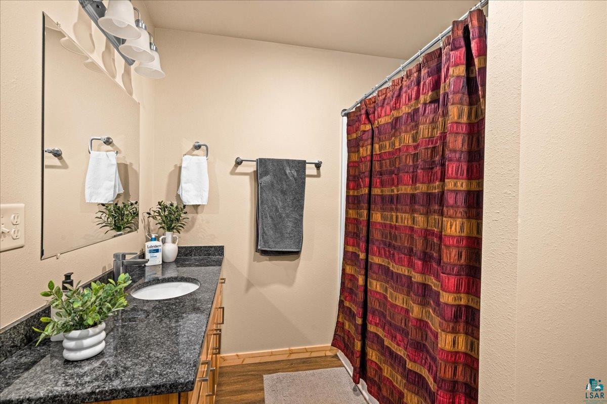 11411 South 3rd Street East Solon Springs, WI 54873 - Photo 18 of 40 features Hickory Cabinetry, Granite Counters, and Combo Tub/Shower.