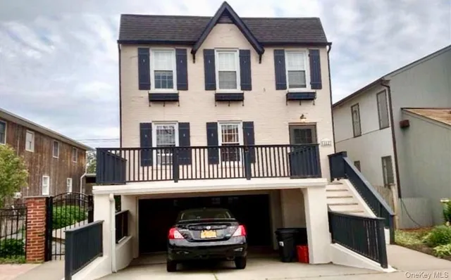 a car parked in front of a white building