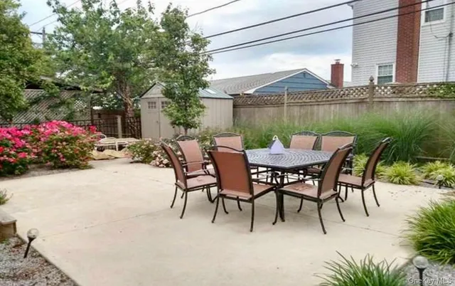 a view of a patio with furniture and a yard