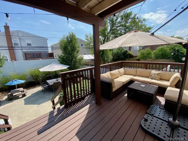 a balcony with wooden floor and furniture