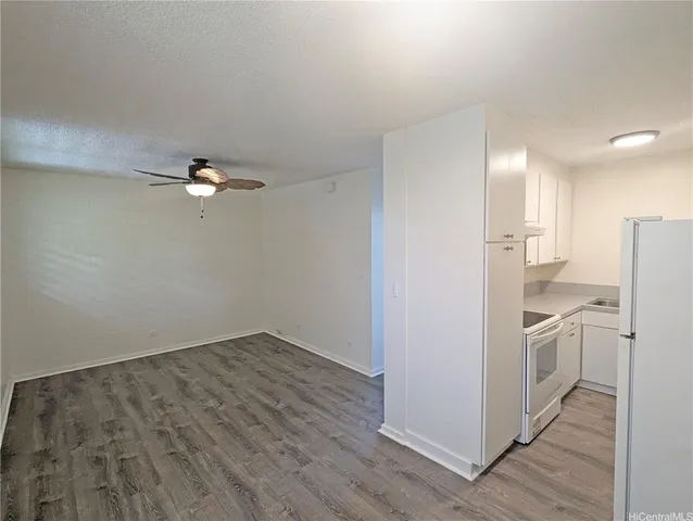 a view of a kitchen with a sink and a refrigerator