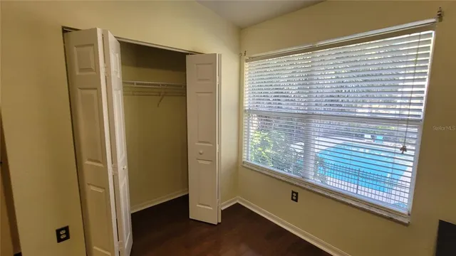 a view of a hallway with windows and entryway