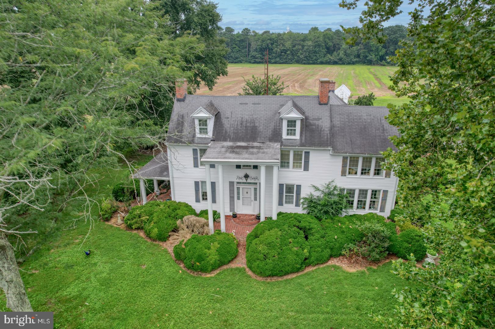 a aerial view of a house with roof deck and garden