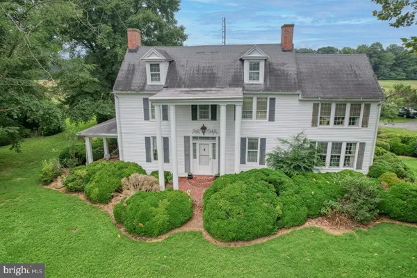 a aerial view of a house next to a yard