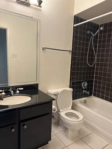 a bathroom with a toilet a sink and shower