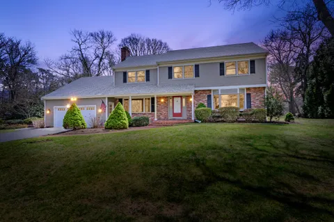 a front view of house with yard and green space