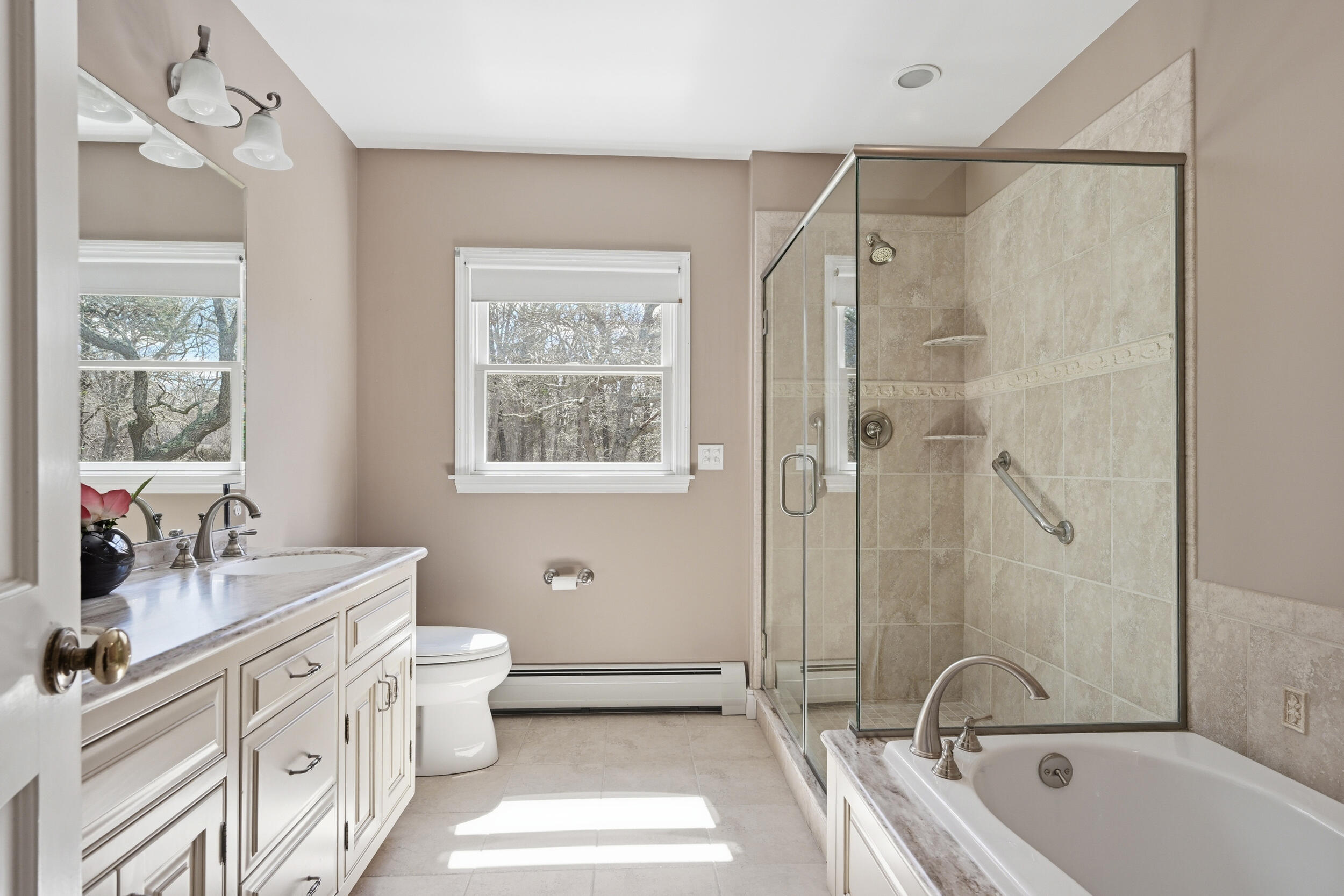 43 Sturgis Lane Barnstable, MA 02630 - Photo 55 of 70 a bathroom with a double vanity sink a large mirror a bathtub and shower
