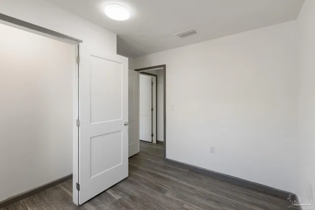 a view of hallway with wooden floor