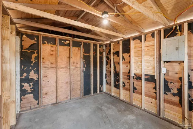 a view of an empty room with floor to ceiling window and an entrance