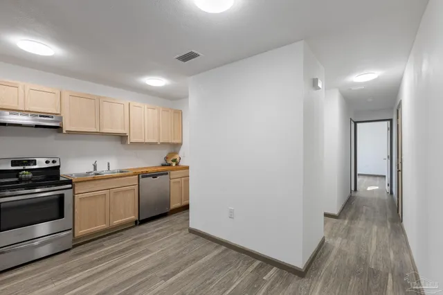 a kitchen with a sink and a stove top oven