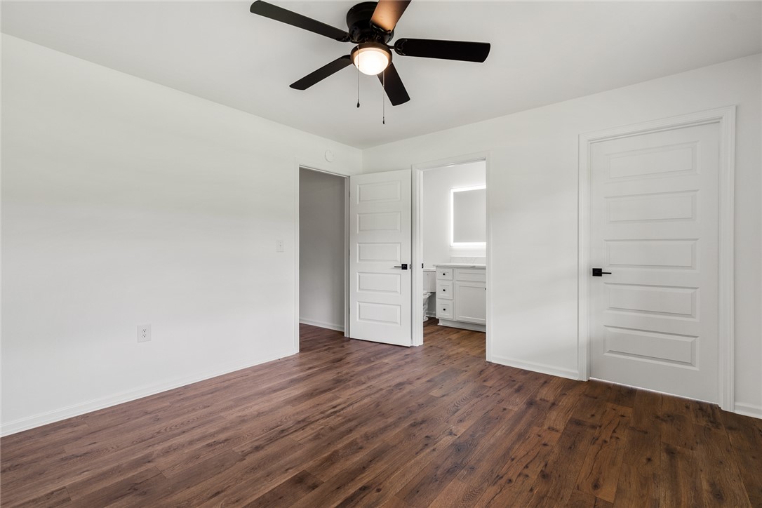 300 Vandiver Road Anderson, SC 29621 - Photo 15 of 30 Rich hardwood floors complement this primary bedroom, offering direct access to an en-suite bathroom.