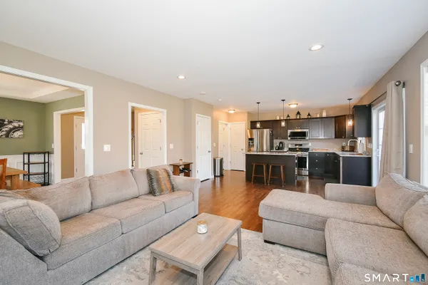 a living room with furniture and kitchen view