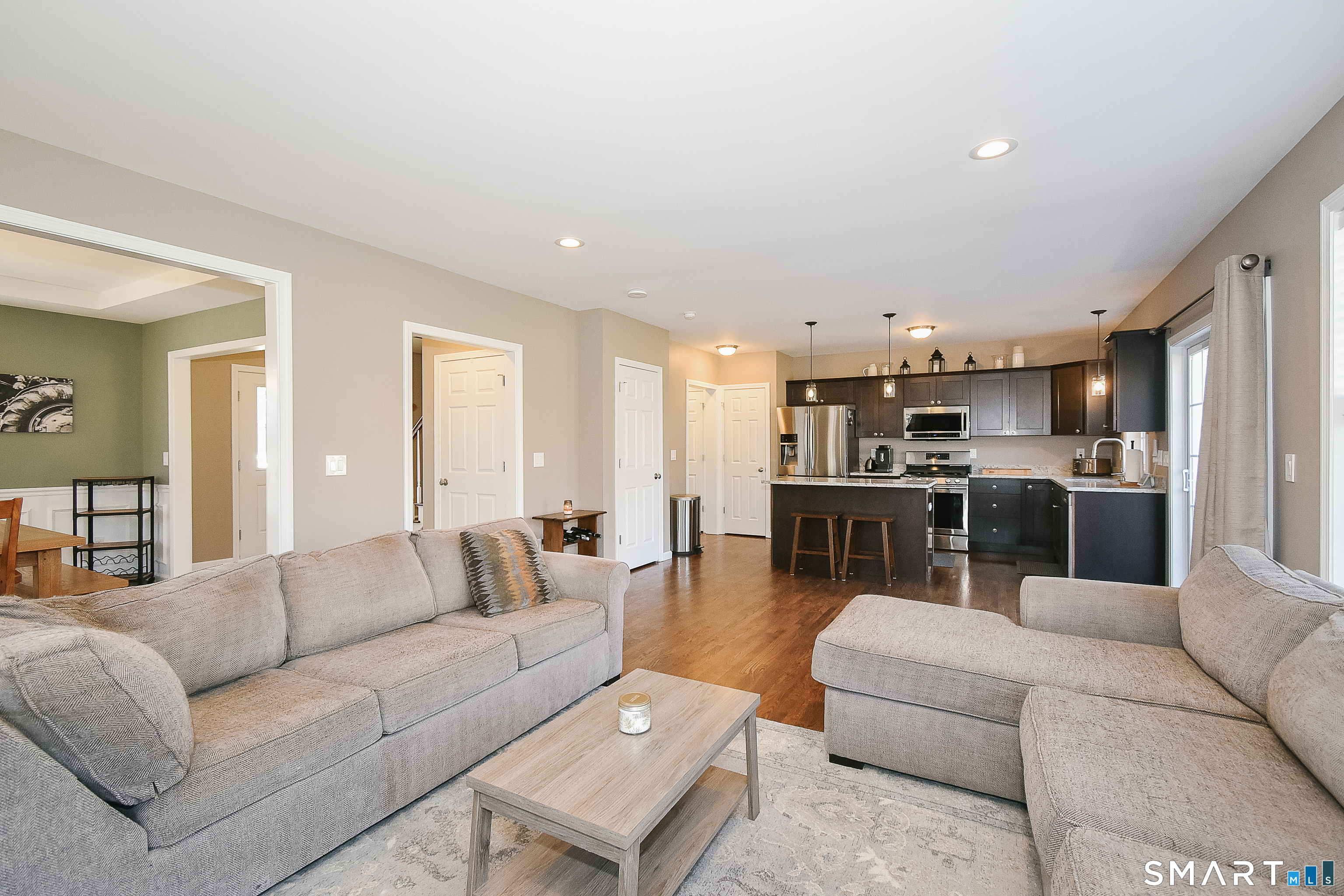 a living room with furniture and kitchen view