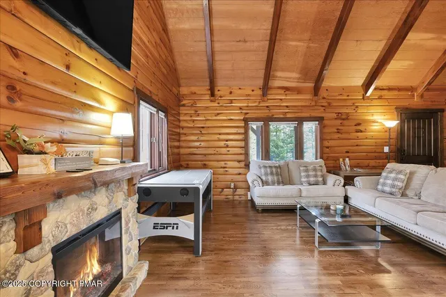 a living room with lots of furniture and kitchen view