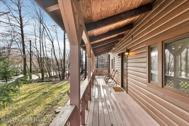a view of a chairs and table on the wooden deck