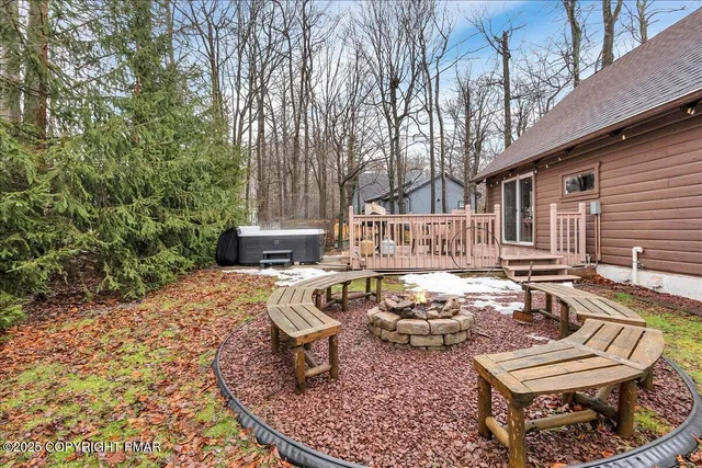 a view of a house with backyard water fountain and sitting area