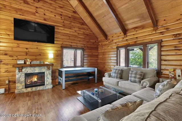 a living room with furniture and a flat screen tv
