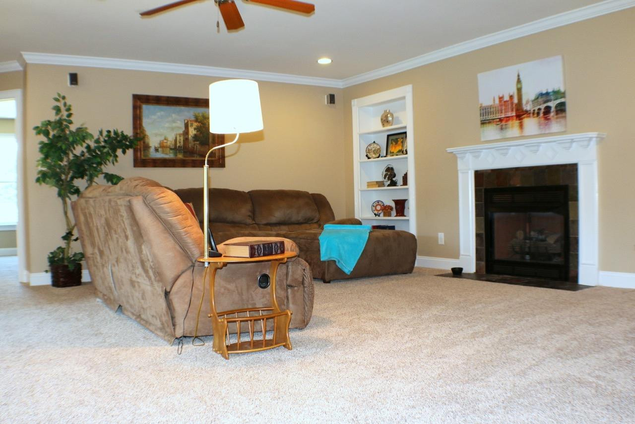 820 Hood Farm Road Clayton, NC 27520 - Photo 10 of 20 Extend your living area into this large Loft with GAS FIREPLACE, built in bookshelves, & ceiling fan. There is a hidden office area behind one of the bookshelves. Loft