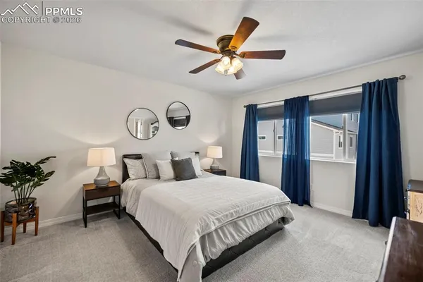 a bedroom with a large bed and a chandelier