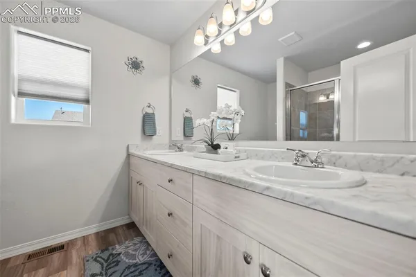 a bathroom with a double vanity sink and a mirror