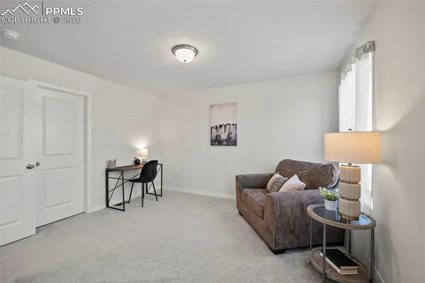 a living room with furniture and a lamp