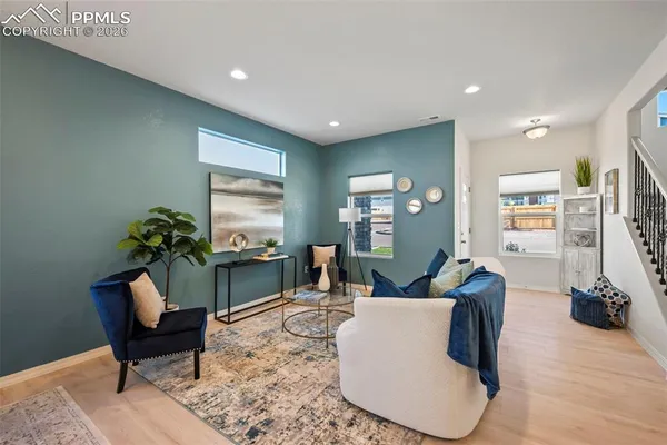 a living room with furniture a window and a flat screen tv