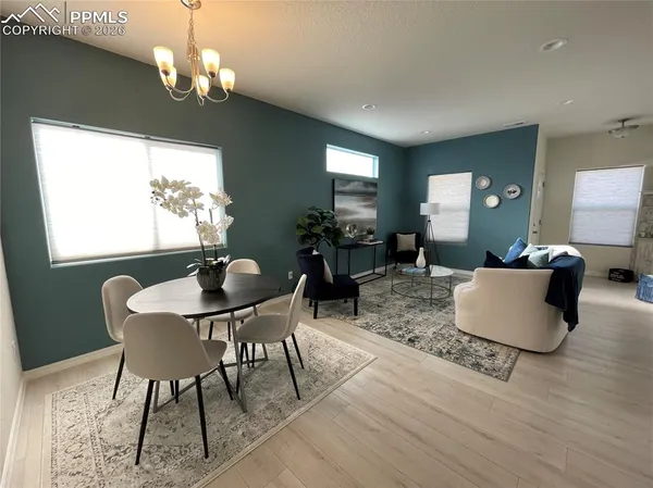 a view of a dining room with furniture window and wooden floor