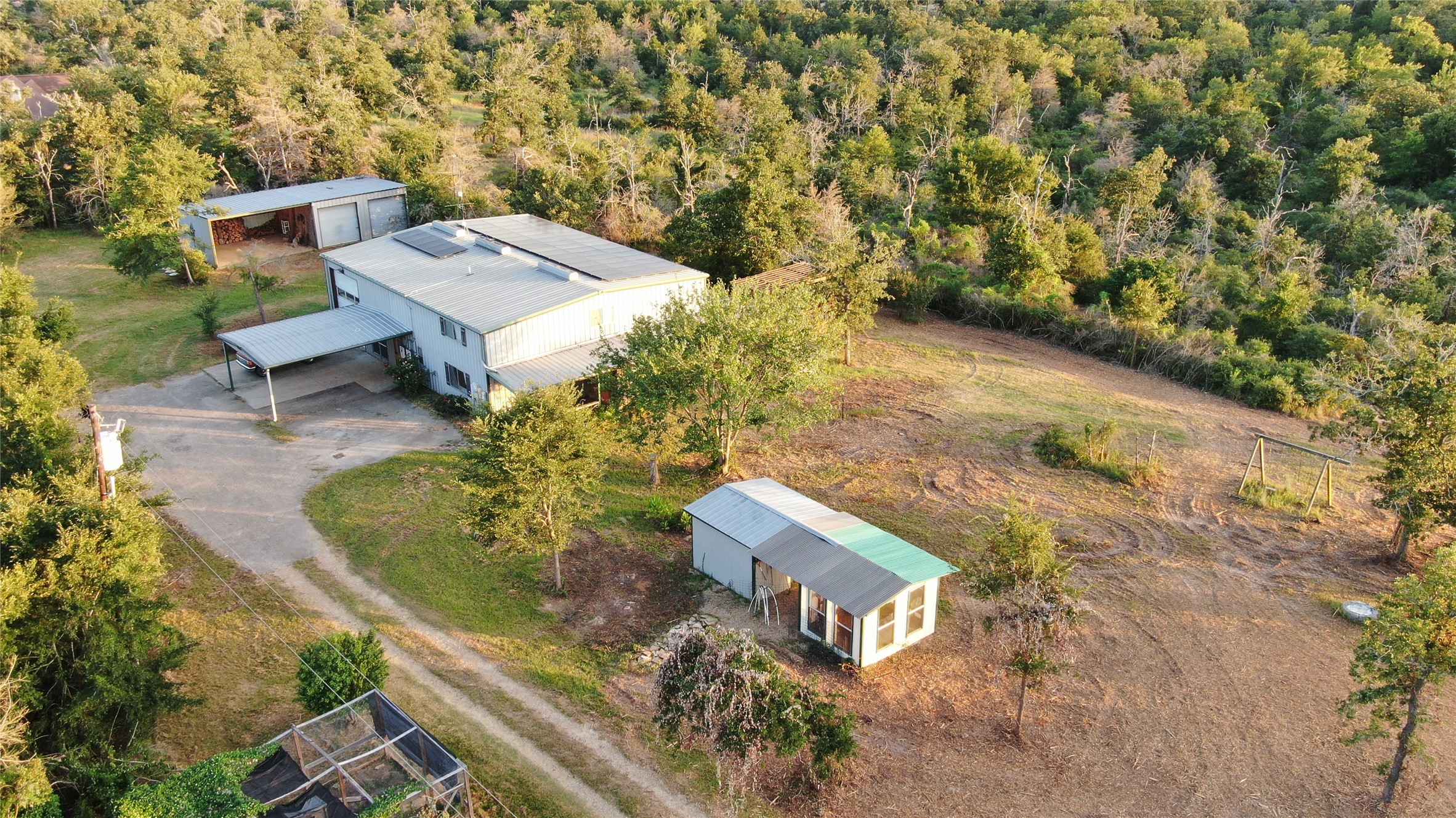 1004 22 Hills Road Gause, TX 77857 - Photo 2 of 37 Discover this private retreat, a metal building home with ample outdoor space and mature trees.