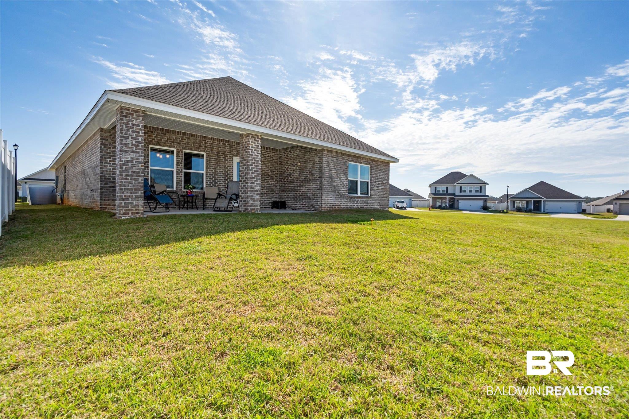24262 Alydar Loop Daphne, AL 36526 - Photo 16 of 33 Rear view of property with a patio area, brick siding, a yard, and roof with shingles