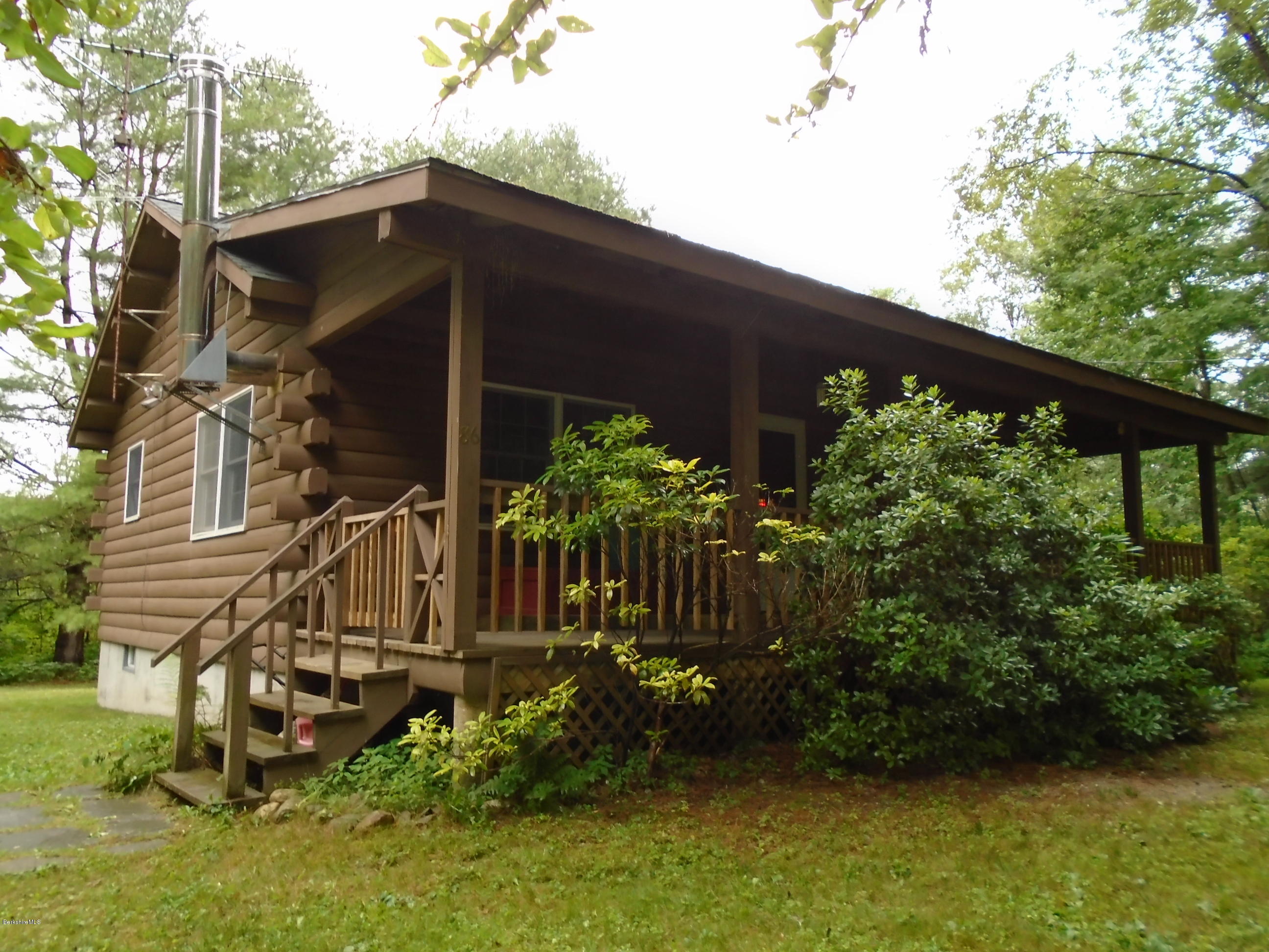 86 Peterson Road Becket, MA 01223 - Photo 1 of 52 a front view of a house with garden