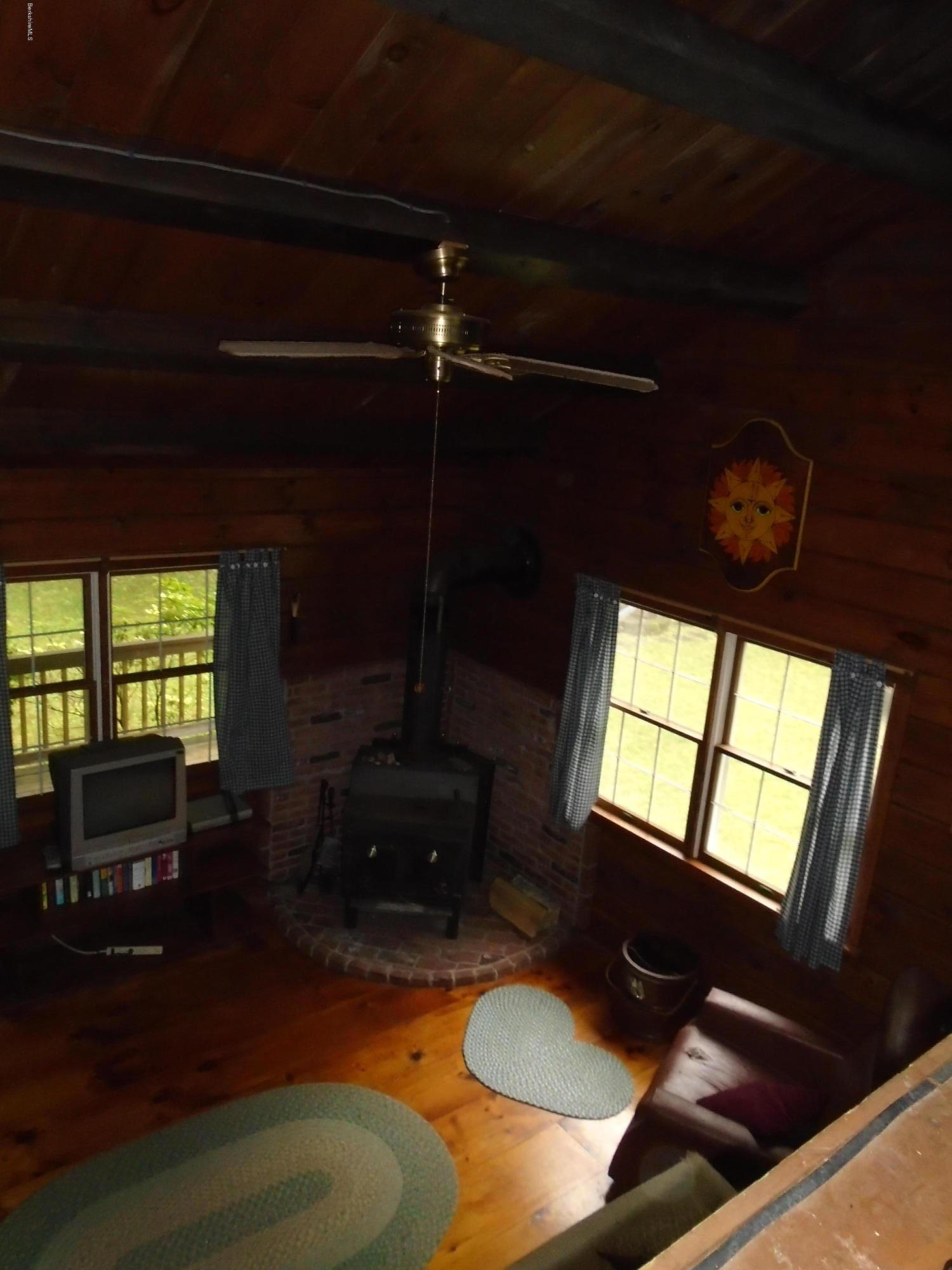 86 Peterson Road Becket, MA 01223 - Photo 11 of 52 a living room with furniture flat screen tv and a fireplace