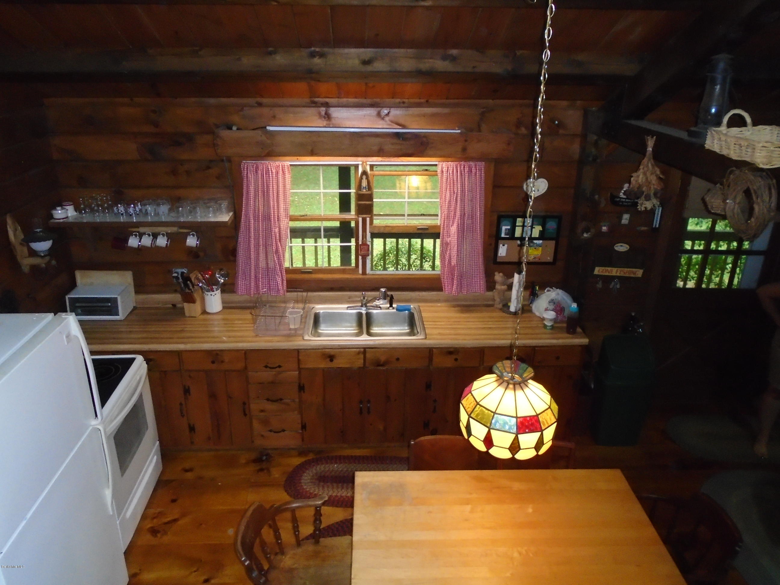 86 Peterson Road Becket, MA 01223 - Photo 14 of 52 a kitchen with a sink and chandelier