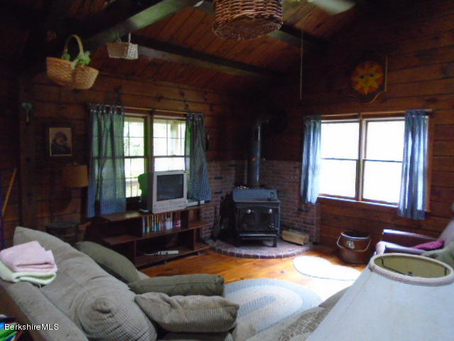 86 Peterson Road Becket, MA 01223 - Photo 4 of 52 a living room with furniture and a fireplace