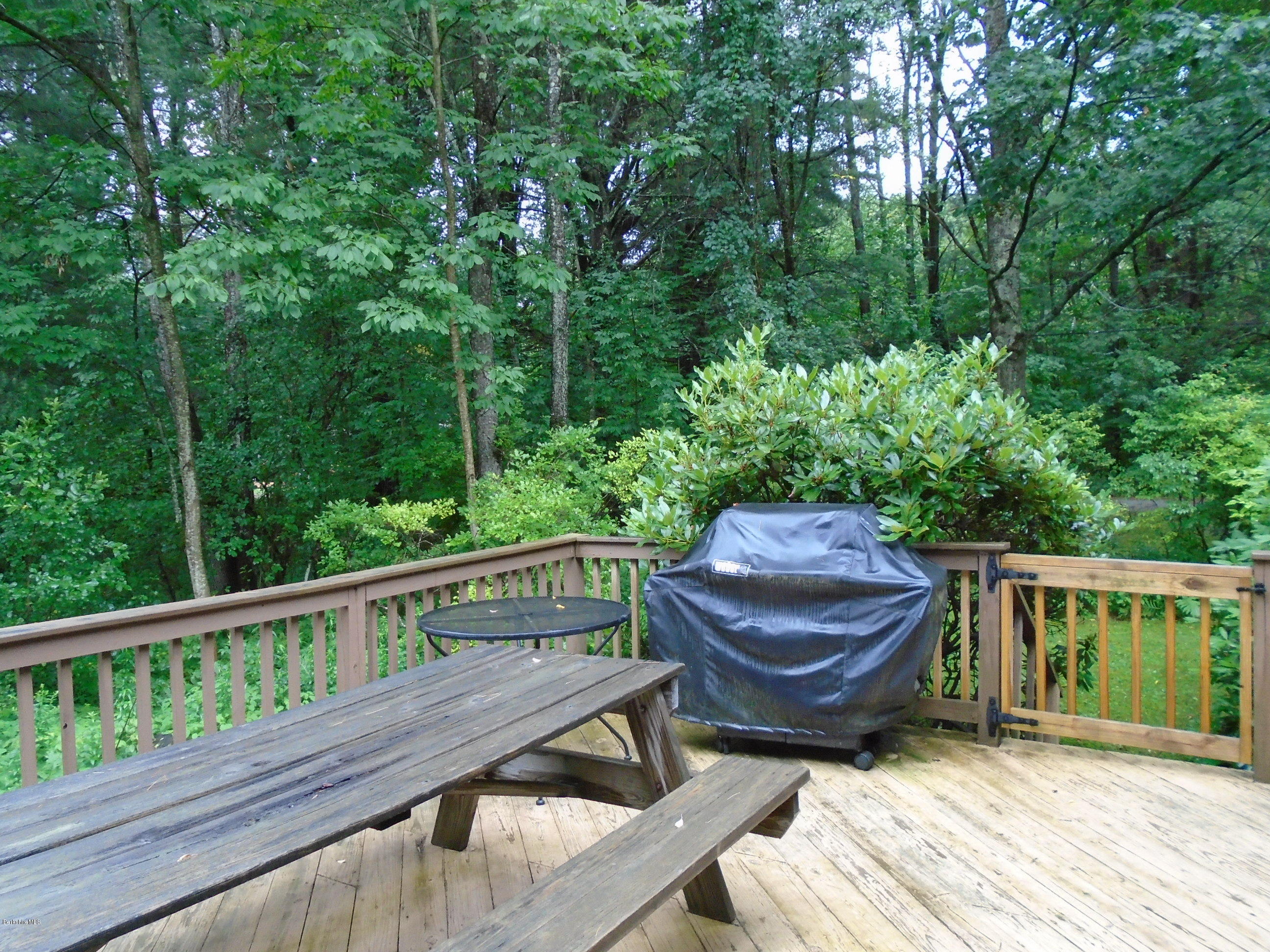 86 Peterson Road Becket, MA 01223 - Photo 35 of 52 a view of a wooden deck and a backyard