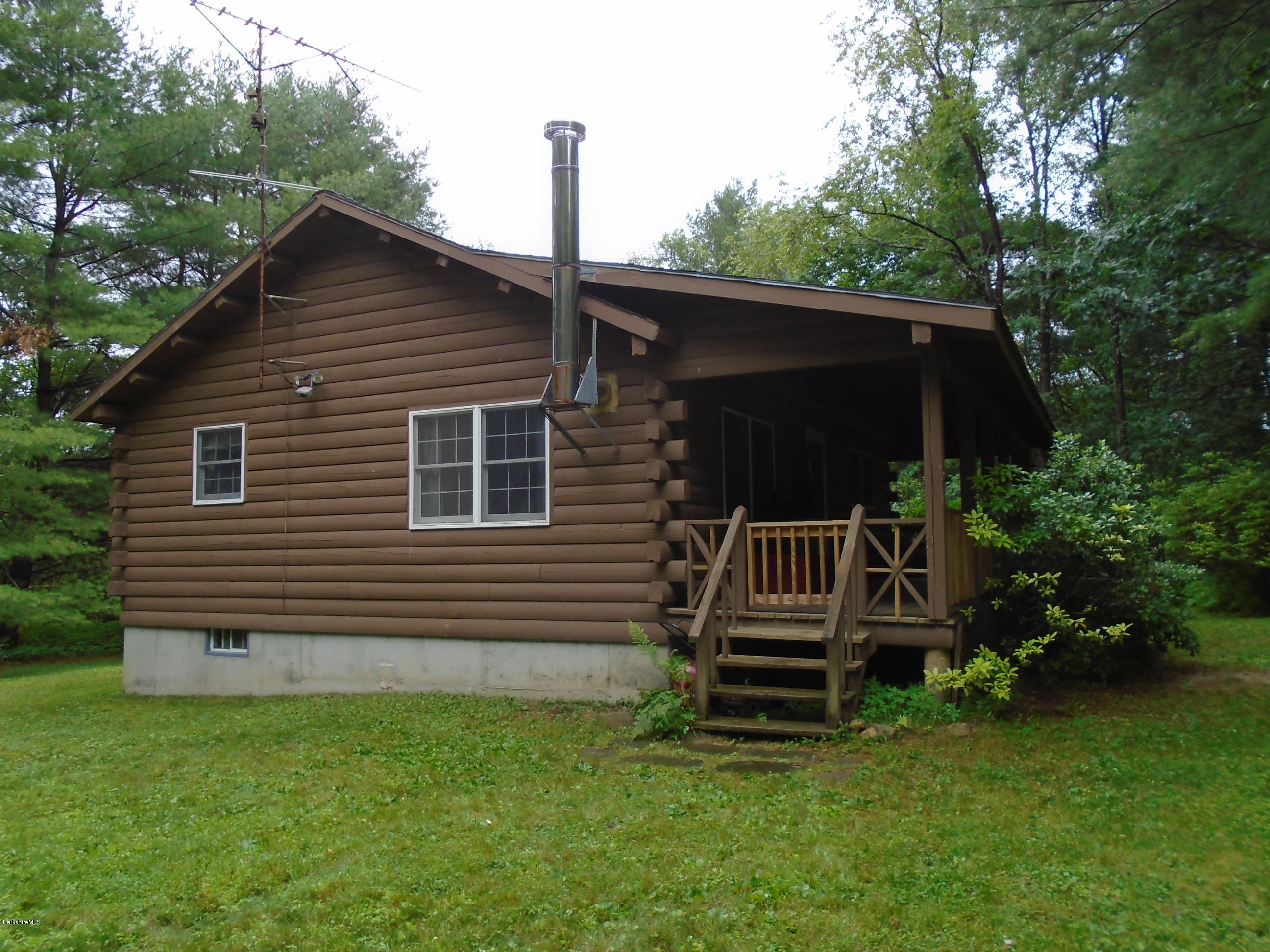 86 Peterson Road Becket, MA 01223 - Photo 40 of 52 a front view of a house with a garden