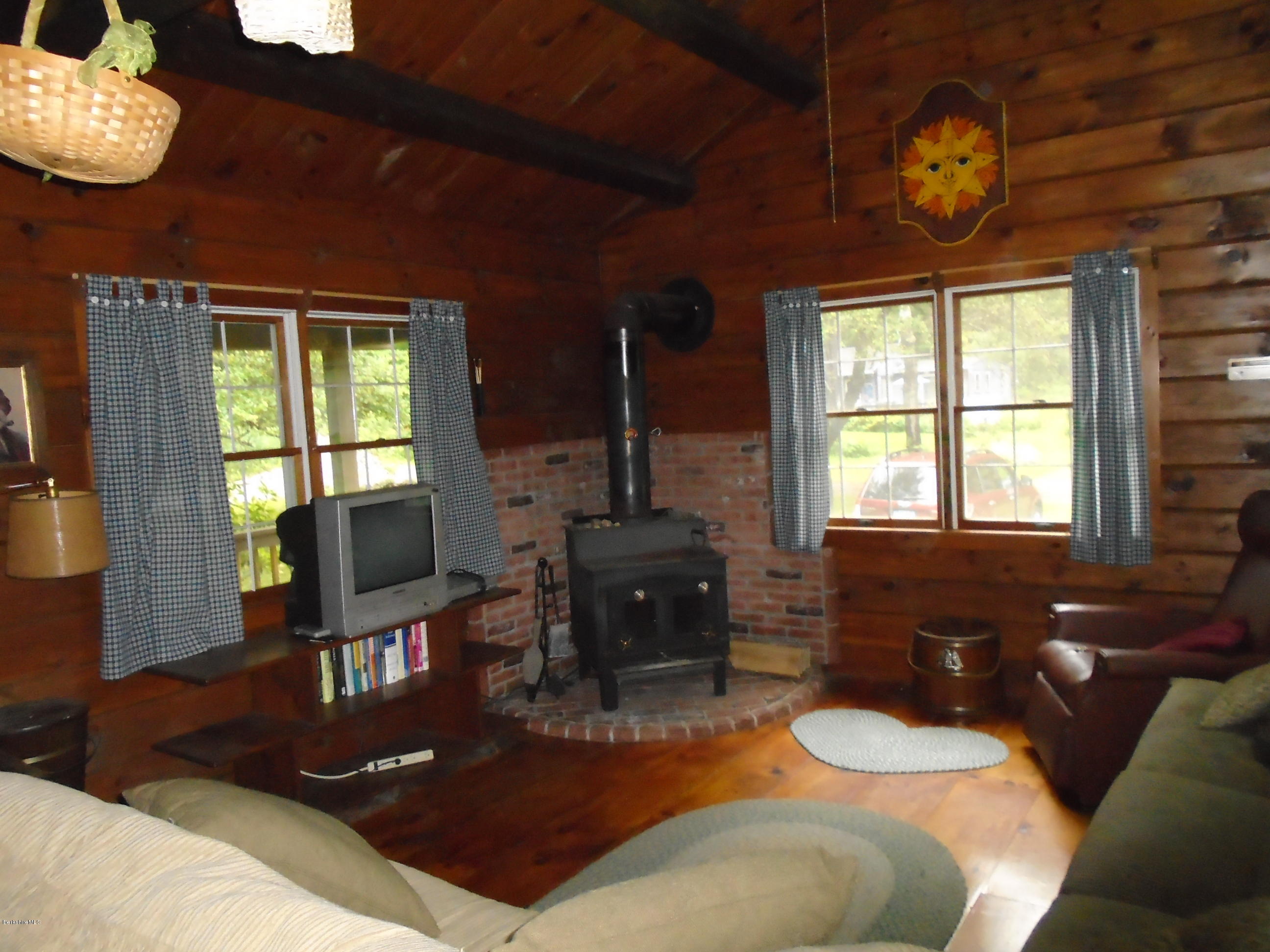 86 Peterson Road Becket, MA 01223 - Photo 5 of 52 a living room with furniture a window and a flat screen tv