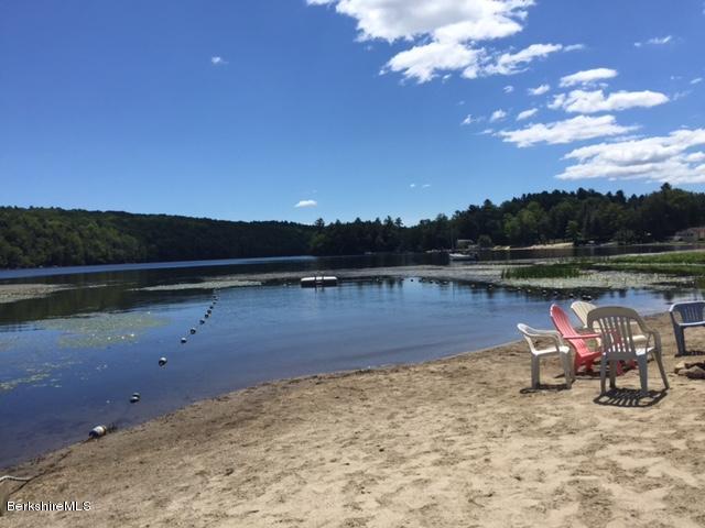 86 Peterson Road Becket, MA 01223 - Photo 44 of 52 a view of a lake with a yard and lake view