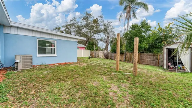 a backyard of a house with table and chairs