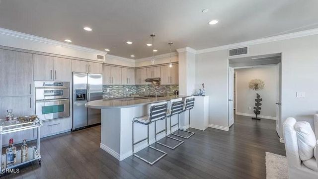 a kitchen with stainless steel appliances granite countertop a refrigerator sink and cabinets