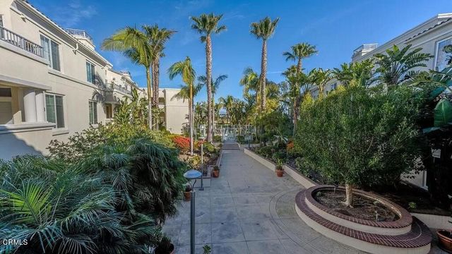 a view of a fountain in front of a house